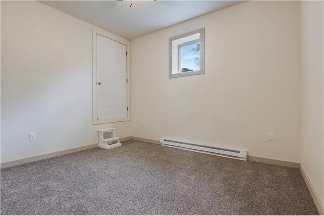 324 Douglas St, Chetek, WI 54728 - empty room featuring baseboard heating, carpet flooring, and baseboards