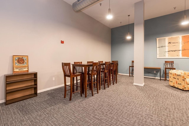 1924 N Hubbard St Unit 208, Milwaukee, WI 53212 - dining room with carpet flooring, baseboards, and a towering ceiling