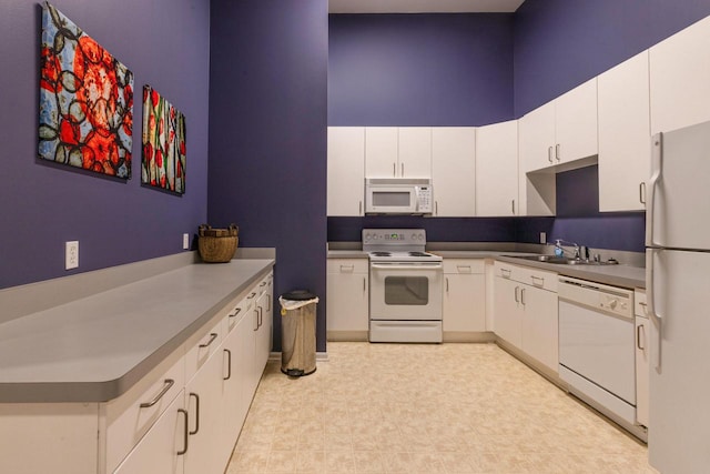 1924 N Hubbard St Unit 208, Milwaukee, WI 53212 - kitchen with white appliances, a towering ceiling, white cabinetry, a sink, and light flooring