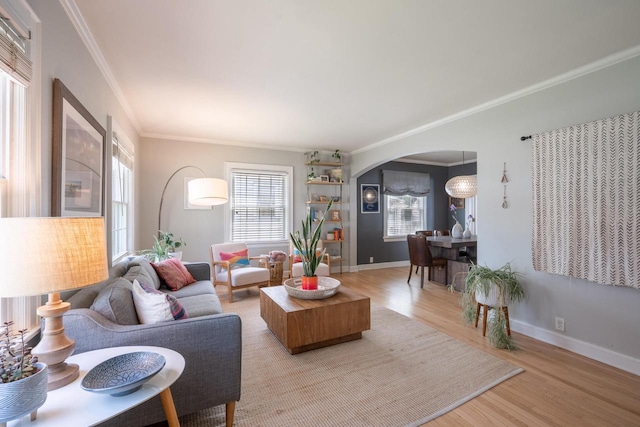 4781 N Idlewild Ave, Whitefish Bay, WI 53211 - living room featuring light wood finished floors, ornamental molding, arched walkways, and baseboards