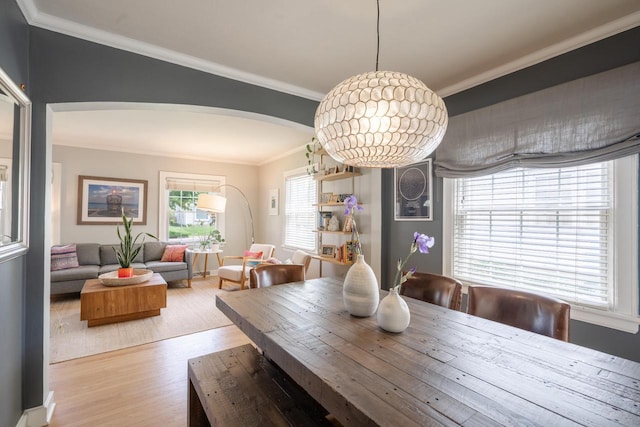 4781 N Idlewild Ave, Whitefish Bay, WI 53211 - dining space featuring arched walkways, wood finished floors, and ornamental molding