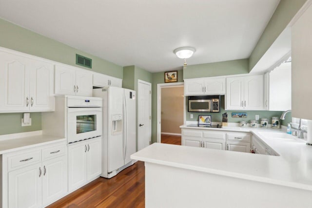 620 S Greenfield Ave, Waukesha, WI 53186 - kitchen featuring white appliances, a sink, white cabinetry, dark wood-style flooring, and light countertops