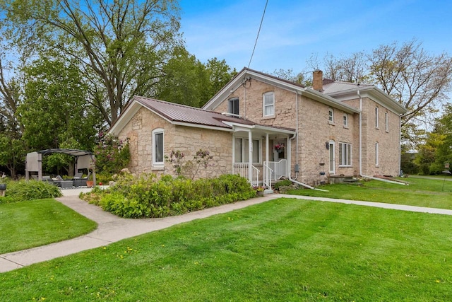 4105 Lime Kiln Rd, Green Bay, WI 54311 - traditional home with a chimney, stone siding, a front lawn, and metal roof