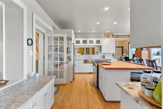 4105 Lime Kiln Rd, Green Bay, WI 54311 - kitchen featuring appliances with stainless steel finishes, butcher block counters, white cabinetry, light wood finished floors, and recessed lighting