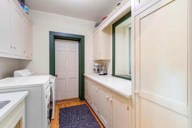 4105 Lime Kiln Rd, Green Bay, WI 54311 - laundry area with cabinet space, washing machine and clothes dryer, and light wood finished floors