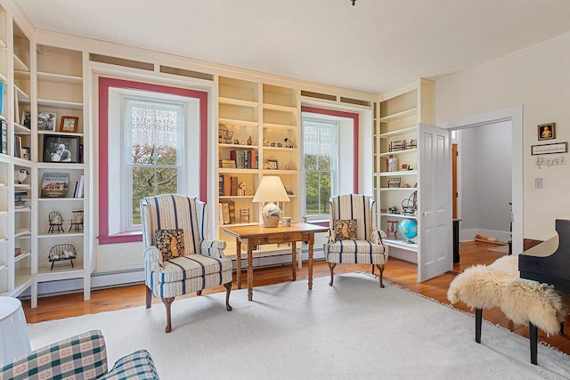 4105 Lime Kiln Rd, Green Bay, WI 54311 - living area with a desk, wood finished floors, built in shelves, and baseboard heating