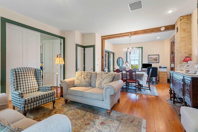 4105 Lime Kiln Rd, Green Bay, WI 54311 - living room featuring a chandelier, light wood finished floors, and beamed ceiling
