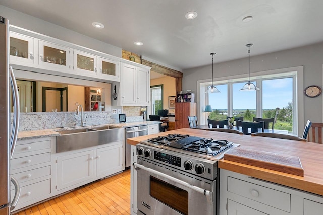 4105 Lime Kiln Rd, Green Bay, WI 54311 - kitchen with appliances with stainless steel finishes, a sink, recessed lighting, plenty of natural light, and white cabinets