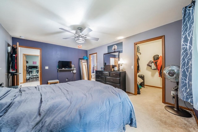 223 Willow Creek Rd, Rosendale, WI 54974 - bedroom featuring light colored carpet, baseboards, a walk in closet, ceiling fan, and connected bathroom