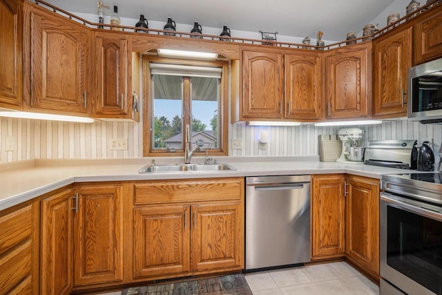 223 Willow Creek Rd, Rosendale, WI 54974 - kitchen featuring stainless steel appliances, a sink, brown cabinets, light countertops, and light tile patterned floors
