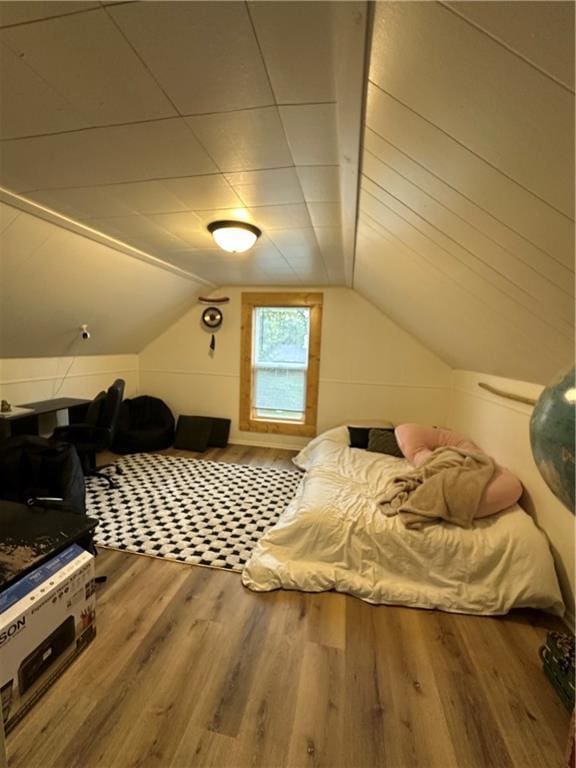 1010 Fillmore St, Black River Falls, WI 54615 - bedroom featuring wood finished floors and lofted ceiling