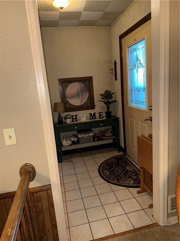 410-4101/2 W Elm St, Chippewa Falls, WI 54729 - entryway with light tile patterned floors and wooden walls