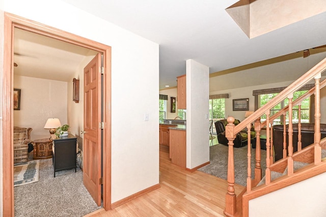 9165 S 47th St, Franklin, WI 53132 - corridor with light wood finished floors, stairs, and baseboards