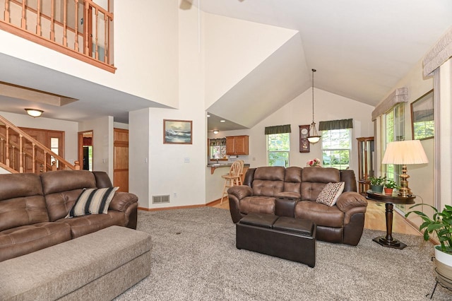 9165 S 47th St, Franklin, WI 53132 - carpeted living room featuring stairs, lofted ceiling, and baseboards