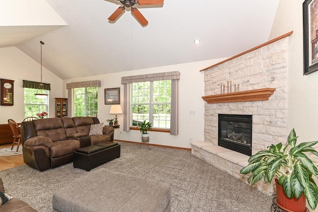 9165 S 47th St, Franklin, WI 53132 - living room with vaulted ceiling, ceiling fan, a stone fireplace, baseboards, and carpet