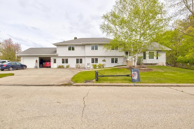 4100 15th St, Menominee, MI 49858 - tri-level home featuring an attached garage, a front lawn, and concrete driveway