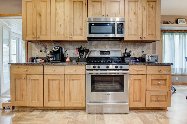4100 15th St, Menominee, MI 49858 - kitchen featuring appliances with stainless steel finishes, light brown cabinets, and tasteful backsplash