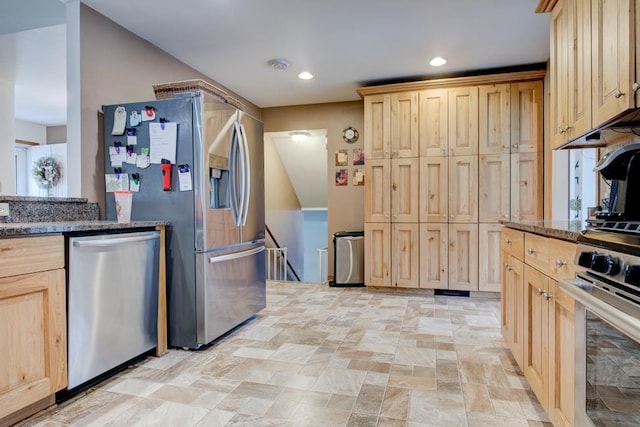 4100 15th St, Menominee, MI 49858 - kitchen with stainless steel appliances, light brown cabinetry, dark stone counters, light stone finish floors, and recessed lighting