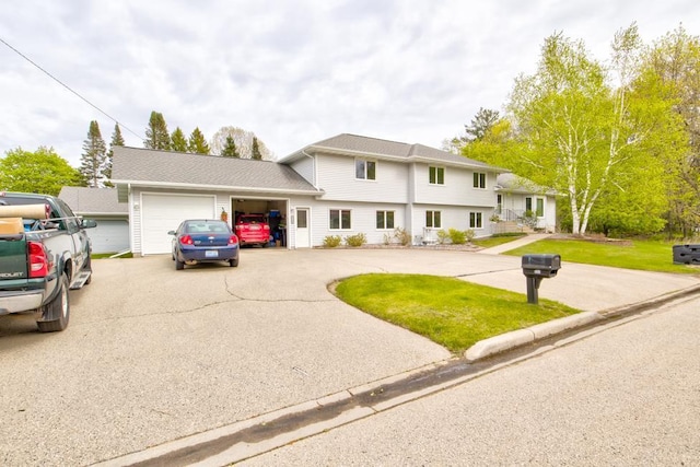 4100 15th St, Menominee, MI 49858 - tri-level home with a garage, asphalt driveway, and a front lawn