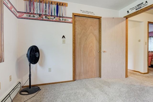 4100 15th St, Menominee, MI 49858 - unfurnished bedroom with a baseboard radiator, carpet flooring, a closet, and baseboards