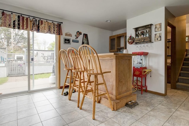 4100 15th St, Menominee, MI 49858 - indoor bar with stairs, baseboards, and light tile patterned flooring