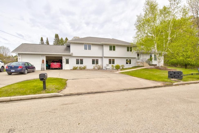 4100 15th St, Menominee, MI 49858 - tri-level home with a garage, a front lawn, and driveway