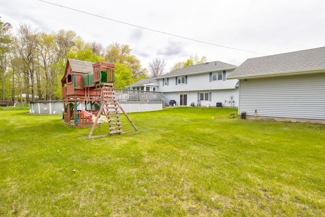 4100 15th St, Menominee, MI 49858 - view of green lawn featuring a playground and cooling unit