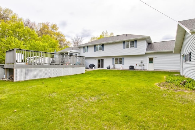 4100 15th St, Menominee, MI 49858 - rear view of property featuring a wooden deck, a lawn, and central AC
