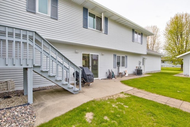 4100 15th St, Menominee, MI 49858 - back of house featuring central AC unit, a yard, and a patio area