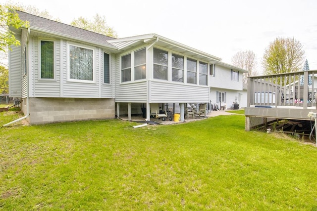 4100 15th St, Menominee, MI 49858 - back of house with a deck, a yard, and a sunroom