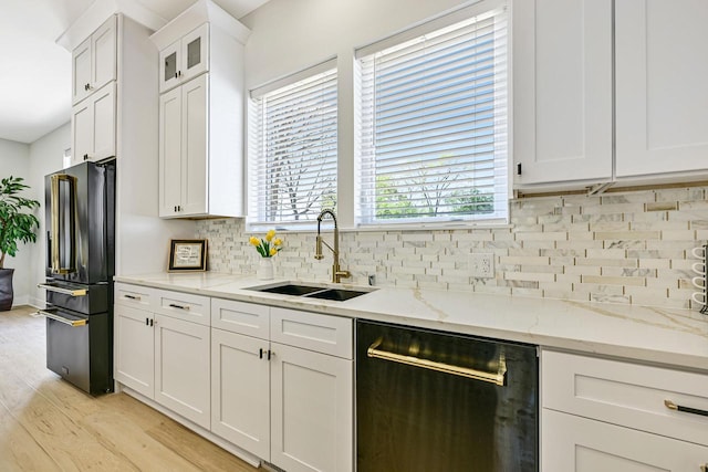 10500 W Vera Ave, Milwaukee, WI 53224 - kitchen with freestanding refrigerator, a sink, dishwashing machine, decorative backsplash, and light wood-type flooring