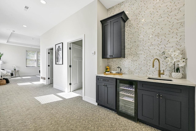 10500 W Vera Ave, Milwaukee, WI 53224 - indoor wet bar featuring wine cooler, backsplash, light colored carpet, baseboards, and recessed lighting
