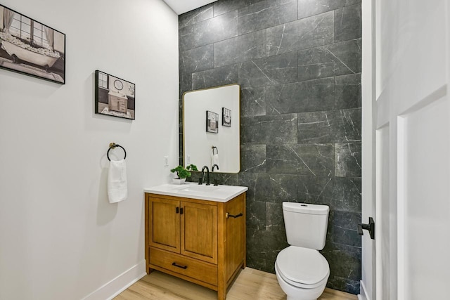 10500 W Vera Ave, Milwaukee, WI 53224 - bathroom with tile walls, vanity, toilet, wood finished floors, and baseboards