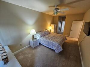 35 Harborview Dr Unit 108, Racine, WI 53403 - carpeted bedroom featuring baseboards and a ceiling fan