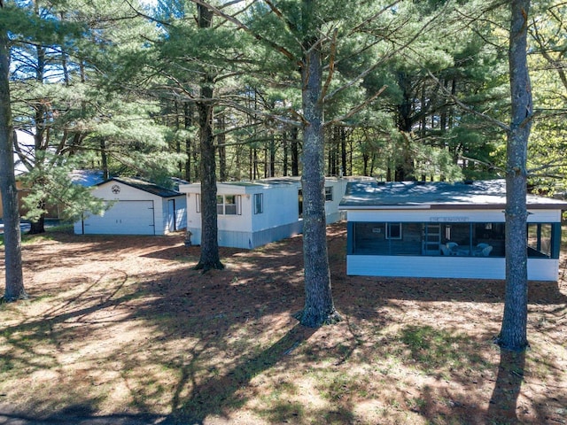 2146 Olmstead St, Friendship, WI 53934 - view of front facade with a sunroom, a garage, and an outbuilding