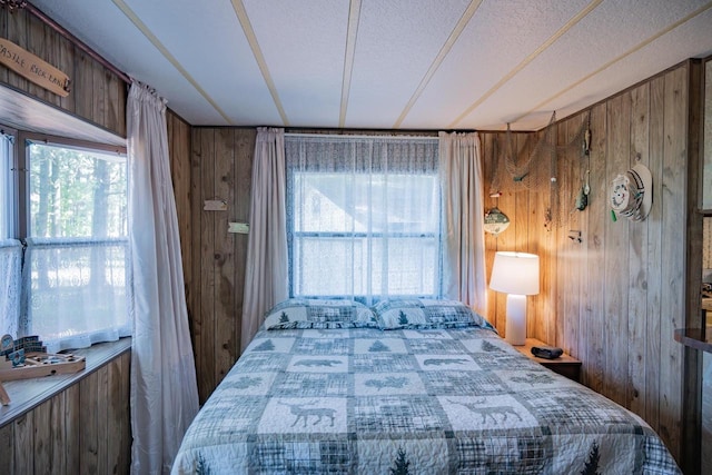 2146 Olmstead St, Friendship, WI 53934 - bedroom featuring wooden walls and multiple windows