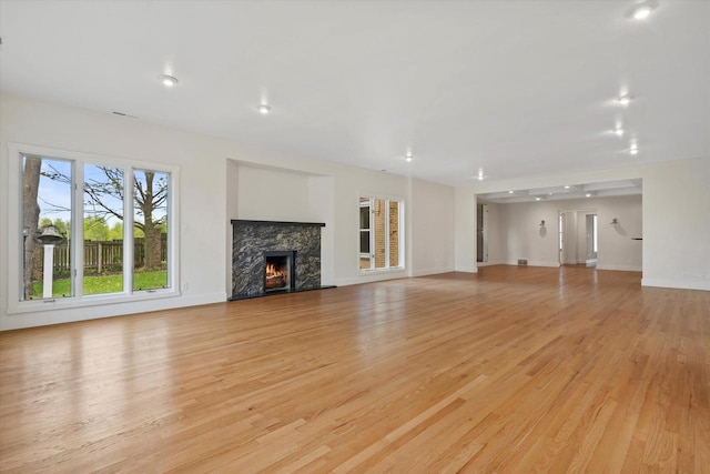 6600 N Ballard Rd, Appleton, WI 54913 - unfurnished living room featuring light wood finished floors, a fireplace, and baseboards