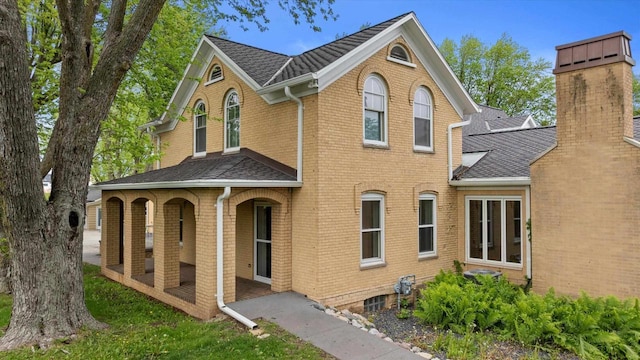 6600 N Ballard Rd, Appleton, WI 54913 - traditional-style home featuring a porch, roof with shingles, brick siding, and a chimney