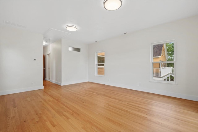 6600 N Ballard Rd, Appleton, WI 54913 - spare room featuring attic access, light wood finished floors, and baseboards