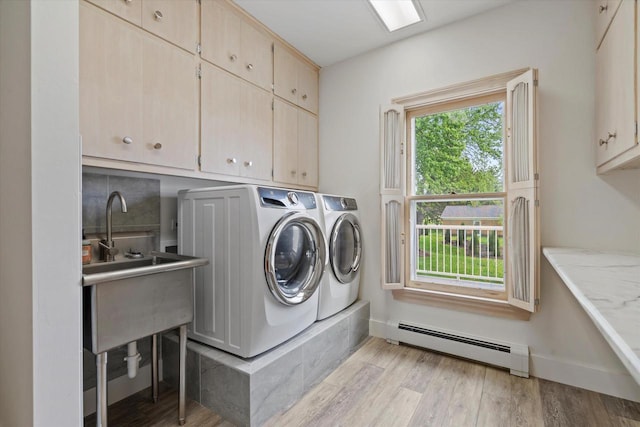 6600 N Ballard Rd, Appleton, WI 54913 - laundry area featuring baseboard heating, cabinet space, washer and dryer, light wood-style floors, and baseboards