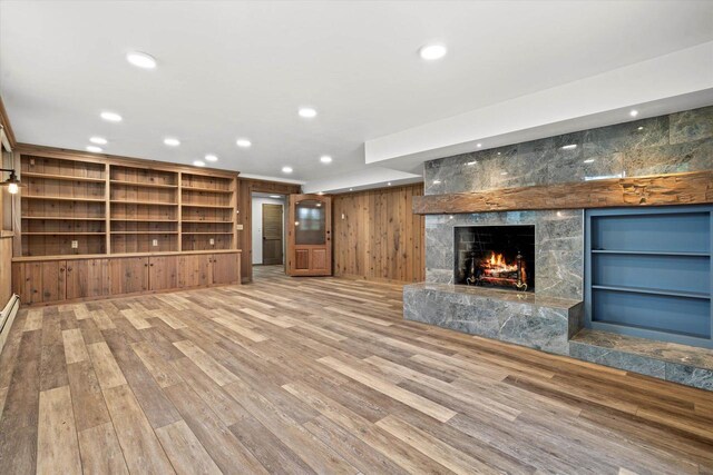 6600 N Ballard Rd, Appleton, WI 54913 - unfurnished living room with a high end fireplace, wood finished floors, recessed lighting, and built in shelves