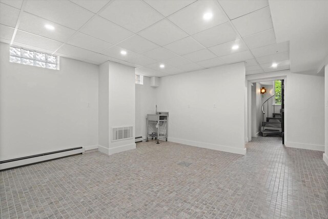 6600 N Ballard Rd, Appleton, WI 54913 - below grade area with healthy amount of natural light, stairs, recessed lighting, a baseboard heating unit, and a drop ceiling