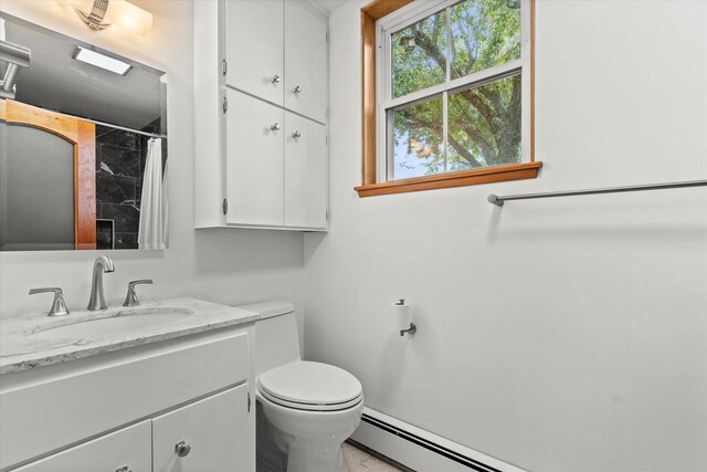 6600 N Ballard Rd, Appleton, WI 54913 - full bath featuring vanity, toilet, a shower with curtain, and baseboard heating