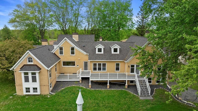 6600 N Ballard Rd, Appleton, WI 54913 - rear view of house featuring a yard, stairway, a wooden deck, and a chimney