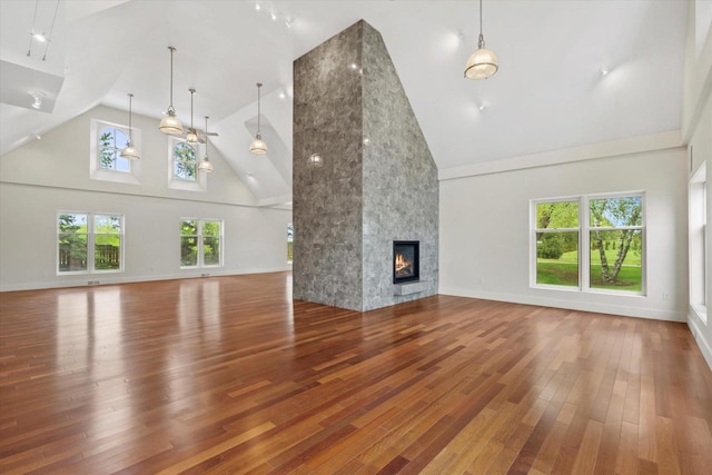 6600 N Ballard Rd, Appleton, WI 54913 - unfurnished living room with high vaulted ceiling, hardwood / wood-style flooring, a premium fireplace, ceiling fan, and baseboards