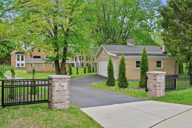 6600 N Ballard Rd, Appleton, WI 54913 - view of side of property featuring a garage, a chimney, driveway, and brick siding