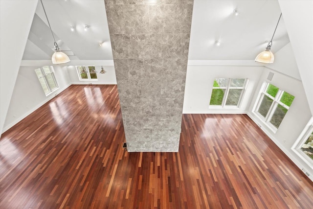 6600 N Ballard Rd, Appleton, WI 54913 - unfurnished living room with healthy amount of natural light, wood finished floors, high vaulted ceiling, and baseboards