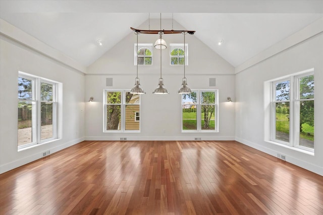 6600 N Ballard Rd, Appleton, WI 54913 - unfurnished living room with high vaulted ceiling, hardwood / wood-style floors, and baseboards