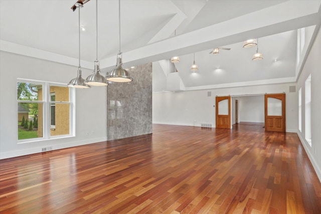 6600 N Ballard Rd, Appleton, WI 54913 - unfurnished living room with wood finished floors, high vaulted ceiling, and baseboards