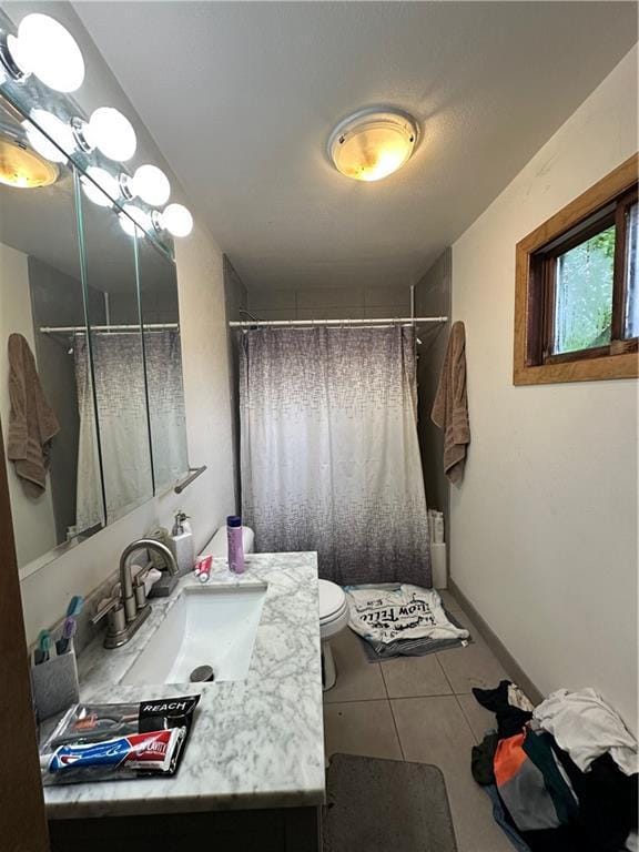315 Armstrong Ave, Black River Falls, WI 54615 - bathroom featuring vanity, toilet, a shower with shower curtain, and tile patterned floors